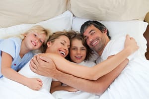 Happy Family in Bed In the Morning